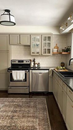 a kitchen with an area rug on the floor