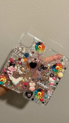 someone is holding up their phone case with lots of stickers on it