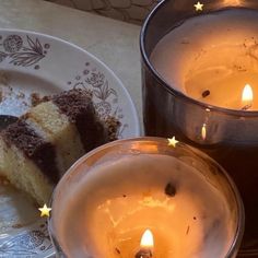 two candles that are next to some cake on a plate and another one has a piece of cake in it