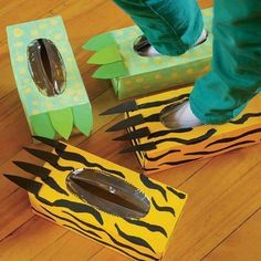 a person standing on top of two boxes with scissors in them and some zebra print