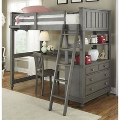 a loft bed with desk underneath and ladder to the top, next to a chair