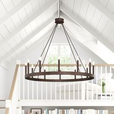 a living room filled with furniture and a book shelf under a chandelier over a fireplace