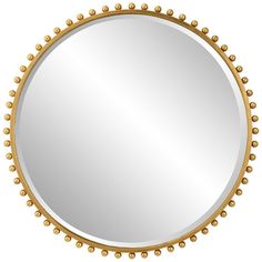 a round mirror with gold beading around it