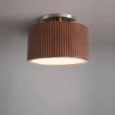 a light that is hanging from the ceiling in a room with gray walls and flooring