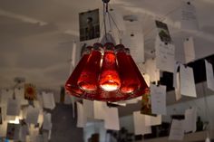 three red glass lamps hanging from a ceiling