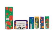 four rolls of lip bales and one tube with flowers on the bottom, all in different colors