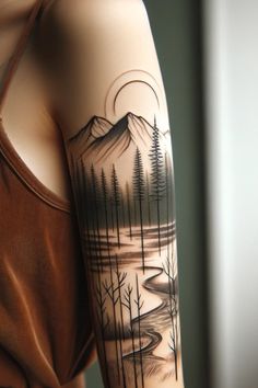 a woman's arm with a mountain scene and trees tattoo on the left side of her arm