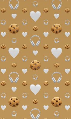 cookies and headphones are arranged in the shape of hearts on a brown background with white heart shapes