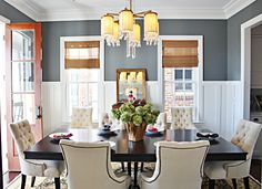 a dining room table with chairs and a chandelier hanging from it's ceiling