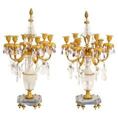 two gold and crystal candelabra on stands