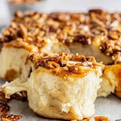 a close up of a cake with pecans on top and one piece cut out