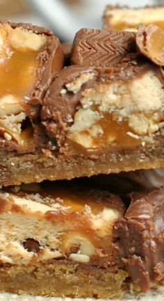 three pieces of chocolate peanut butter bars stacked on top of each other with caramel toppings