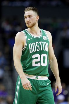 boston basketball player in green uniform standing on the court