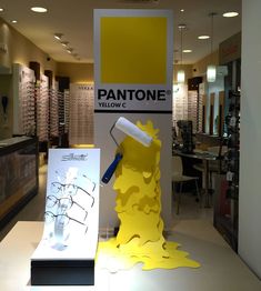 a pantone eyeglass store display with yellow paint on the floor and glasses behind it