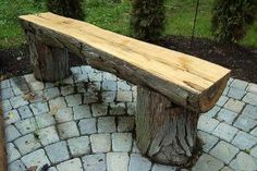 a wooden bench sitting on top of a stone walkway