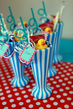 candy in striped cups with rubber ducky on the top and name tags attached to them