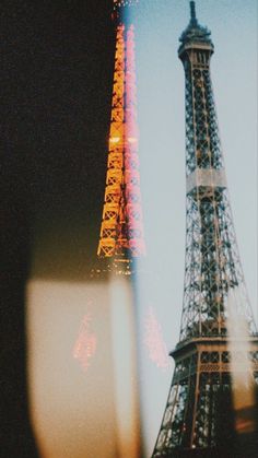 the eiffel tower is lit up at night