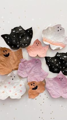 paper bats are arranged on a white surface with stars and sparkles around the edges