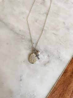 This beautiful Sterling Silver First Communion Gift with "Miraculous Medal" necklace is accented with a dainty cross charm and pearl charm. It floats on a 14" sterling silver Italian chain. It is a perfect Baptism, First Communion or Confirmation gift for girls. The necklace comes in a beautiful black and pink gift box. A keepsake she will treasure forever! This comes packaged on a special first communion card making it an extra special keepsake for her special day. Sterling Silver Charm Necklace With Cross Pendant, Dainty Silver Necklace With Miraculous Medal, Silver Crucifix Necklace With Charms, Silver Cross Necklace With Pearl Charm, Silver Cross Pendant Charm Necklace, Sterling Silver Necklace For First Communion, White Sterling Silver Necklace For First Communion, Personalized Silver Necklace For First Communion, Sterling Silver White Gold Necklace For First Communion