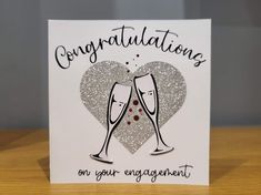 congratulations card with two champagne flutes in the shape of a heart