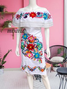 "Lace Trim Off the shoulder tie back Mexican dress with beautiful floral embroidery.Made out of manta, 100% cotton. Please note: Embroidery may be slightly different from the one pictured , each piece is unique. Dimensions: Medium Bust- 46\" Hips- 46\" Waist- 46\" Length- 36\" Large Bust- 47\" Hips- 47\" Waist- 47\" Length- 38\" XL Bust- 50\" Hips- 50\" Waist- 50\" Length- 39\" 🧵Made in Chiapas, Mexico. 🧺Care Instructions: We recommend hand washing, lay flat to dry. 📲Please feel free to messa Bohemian Off-shoulder Embroidered Dress, Mexican Quinceanera Dresses, Fiesta Dress, Mexican Embroidered Dress, Mexican Dresses, Peasant Dress, Quinceanera Dresses, Embroidered Dress, One Pic