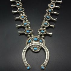 "VINTAGE NAVAJO SQUASH BLOSSOM NECKLACE DESCRIPTION: This necklace boast gorgeous specimens of high blue Kingman turquoise. The gemstones are secure in sawtooth bezel, on a foundation of heavy gauge vintage sterling silver. Each blossom is adorned with an applied leaf accent, as is the crest of the naja. This stunning necklace will be a valuable addition to your collection of fine vintage Native American jewelry. MEASUREMENTS: Necklace measures 26\" end to end Naja measures 3\" x 2 1/2\" Beads a Turquoise Squash Blossom, Vintage Native American Jewelry, Flower Wall Stickers, Squash Blossom Necklace, Squash Blossom, Vintage Navajo, Kingman Turquoise, Wedding Jewellery Necklace, Vinyl Art