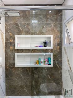 a bathroom with two shelves on the wall