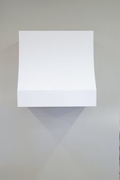 a white square object hanging on the wall