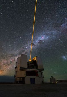 the milky is shining brightly in the sky above an astronomical telescope with its lights on