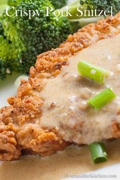 chicken with gravy and broccoli on a plate