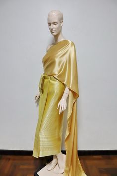 "Gold tone Thai/ Khmer outfit or \"Chut thai\" for women. Occasions: Songkran festival, Loy krathong festival, bride made dress, Thai fair, Thai exibition, attended Thai wedding, temple ceremony, making merit etc. The set consists of 1.Finished wrap around skirt made from brocade faux silk fabric, the skirt can be adjust by hooks Waist: maximum up to 32 in. (81 cm) Hips: maximum up to 42 in. (107 cm) Length: approx. 35.5 in. (90 cm) 2.Satin plain color Thai shawl/ sabai Measurement: 18 in. x 118 Traditional Sarong For Festivals, Khmer Outfit, Loy Krathong Festival, Loy Krathong, Songkran Festival, Festival Bride, Thai Wedding, Ancient Designs, Real Gold Jewelry