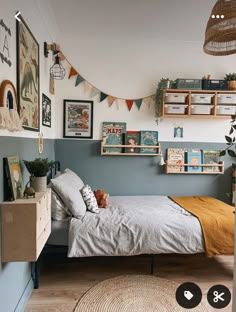 a bed room with a neatly made bed and lots of pictures on the wall above it