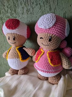 two crocheted teddy bears dressed in different outfits