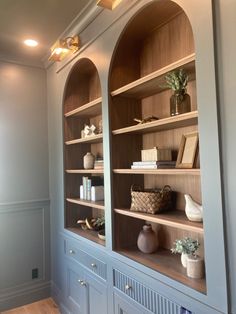 the shelves in the room are lined with vases and books