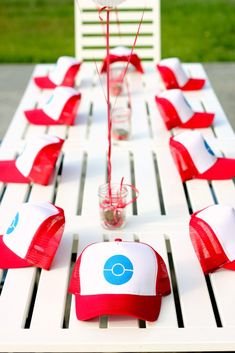 a long table with red and white hats on it