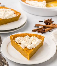 two plates with slices of pumpkin pie on them