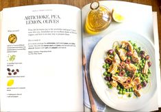 an open recipe book with a plate of food on it