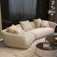 a living room filled with lots of furniture and pillows on top of a carpeted floor