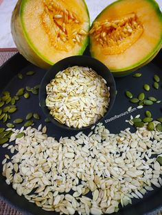 a plate with seeds and watermelon cut in half on top of each other