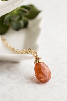 "Beautiful gold faceted sunstone pendant necklace. 14K gold filled wire wrapped sunstone briolette, warm orange with little sparkly inclusions - gorgeous! SO MUCH SPARKLE!! Pictures just don't do this stone justice! One of my favorite stones! I wrap the briolettes in 14k gold filled wire and suspend from gold filled chain. Sunstone is a nature stone and my contain specks inclusions and fissures, this does not effect the quality of the stone and is part of the inherent nature of natural stones. P Sparkle Pictures, Sundance Style Jewelry, Sunstone Jewelry, Butterfly Earrings Gold, Memorial Ring, Peridot Necklace, Sterling Silver Jewelry Handmade, Gold Necklace Women, Pendant Gold