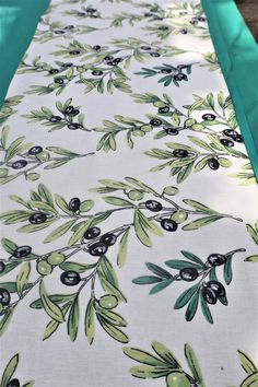 the table cloth has an olive design on it