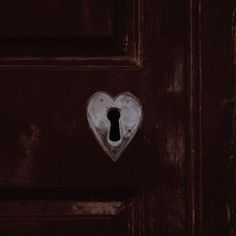 a heart shaped lock on a red door