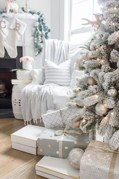 a white christmas tree with gold and silver ornaments