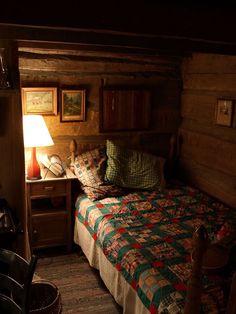 a bed in a room with wooden walls