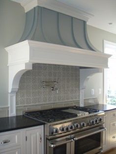 a stove top oven sitting inside of a kitchen