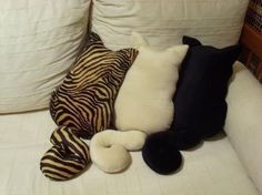 the pillows are laying on the couch next to the pillowcases and one has a zebra print