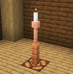 a candle is placed on top of a block in the middle of an empty room