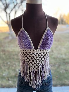 Beautifully handmade crochet bikini top. These look amazing paired with your favorite flannel or just with your favorite shorts and sandals! One size fits most.  The back and top tie so they are very adjustable. The cup size is universal depending on how much coverage you want. This style is very flattering on many different body styles. Colors are purple and cream. Can also be made in colors of your choice. Message the shop to create your own colors! Handmade Triangle Halter Top For Beach Season, Handmade Triangle Halter Top For Beach, Handmade Triangle Halter Top For Summer, Adjustable Bohemian Halter Top For Festivals, Handmade Triangle Top Crop For Beachwear, Adjustable Crop Top For Summer Beach, Handmade Triangle Halter Top For Festivals, Adjustable Halter Top For Beach Festival, Adjustable Halter Top For Festival Beachwear