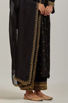 Black chanderi silk kurta with sequin, floral embroidery and V neckline. Paired with pant and dupatta.
Component: 3
Pattern: Embroidery
Type Of Work: Floral, sequin
Neckline: V neck
Sleeve Type: Long sleeves
Fabric: Chanderi Silk
Color: Black
Other Details: 
Embroidered sheer dupatta
Occasion: Sangeet - Aza Fashions Dola Silk Kurta With Gota Work In Traditional Drape, Dola Silk Kurta With Gota Work, Chanderi Palazzo Set With Resham Embroidery For Diwali, Designer Raw Silk Semi-stitched Kurta, Designer Semi-stitched Raw Silk Kurta, Designer Traditional Drape Palazzo Set With Zari Work, Unstitched Palazzo Set With Zari Work In Raw Silk, Traditional Drape Designer Palazzo Set With Zari Work, Straight Kurta With Gota Work In Dola Silk