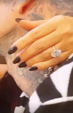 a woman with black and white nail polish on her nails